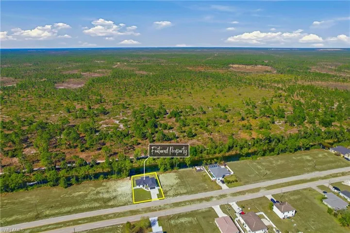 Aerial overview of property's location with property boundaries highlighted and a forest