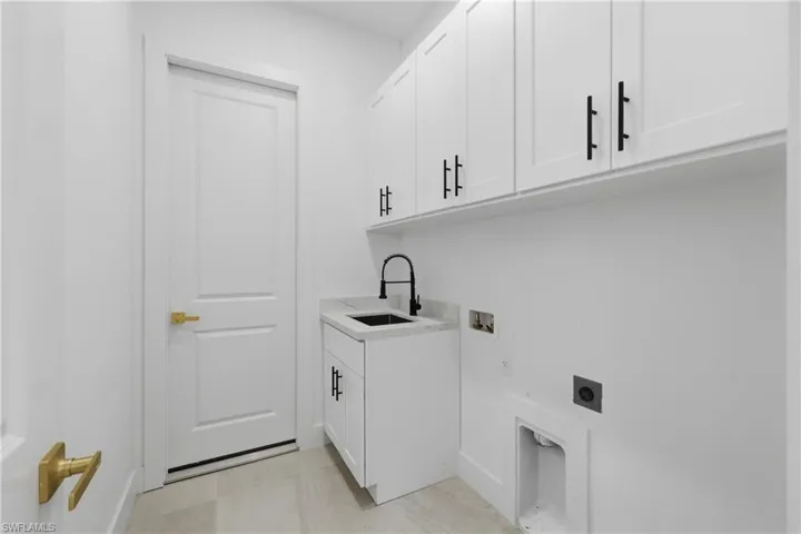 Laundry area with hookup for an electric dryer, cabinet space, and hookup for a washing machine