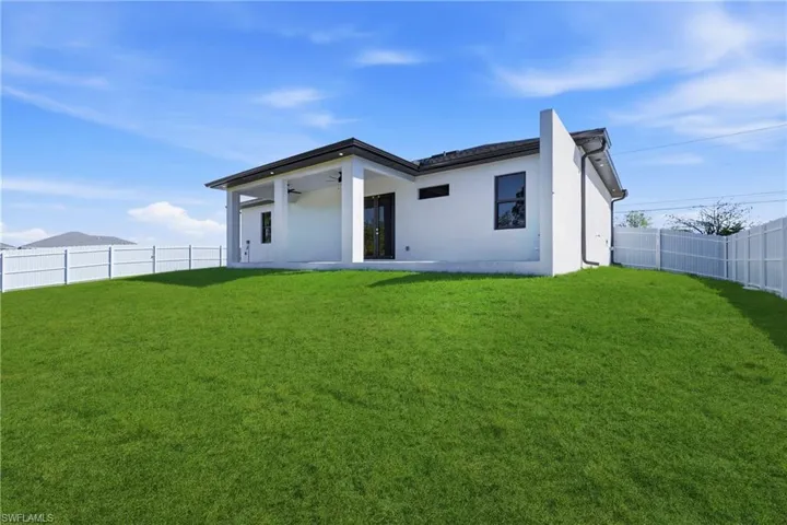 Back of house featuring a patio, a fenced backyard, ceiling fan, and stucco siding