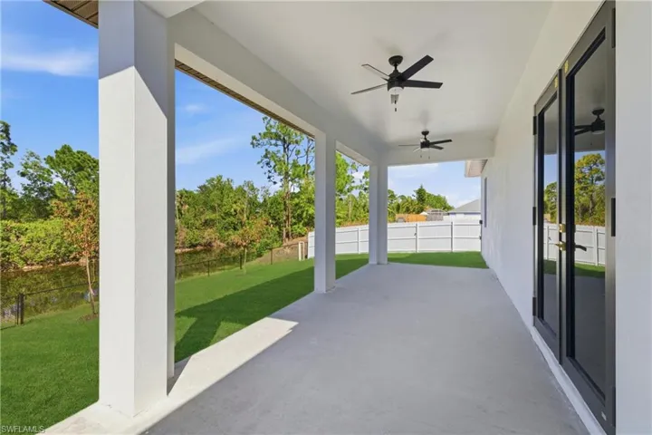 Fenced backyard with a patio area and ceiling fan