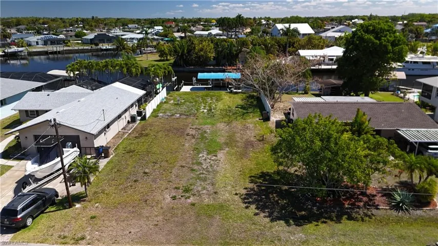 Aerial perspective of suburban area featuring a large body of water