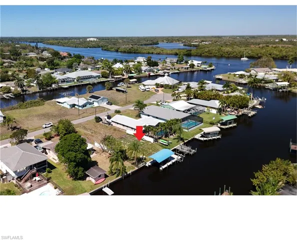 Aerial perspective of suburban area featuring a nearby body of water