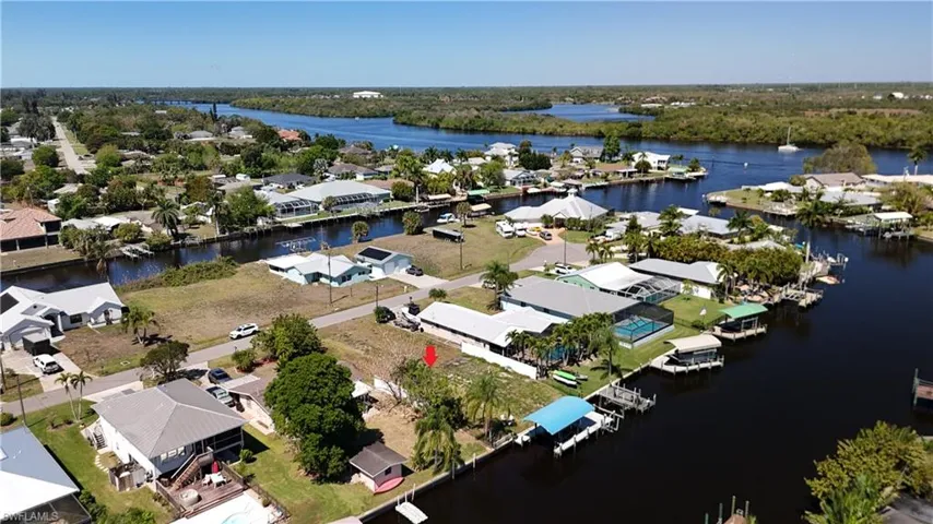 Aerial perspective of suburban area featuring a large body of water