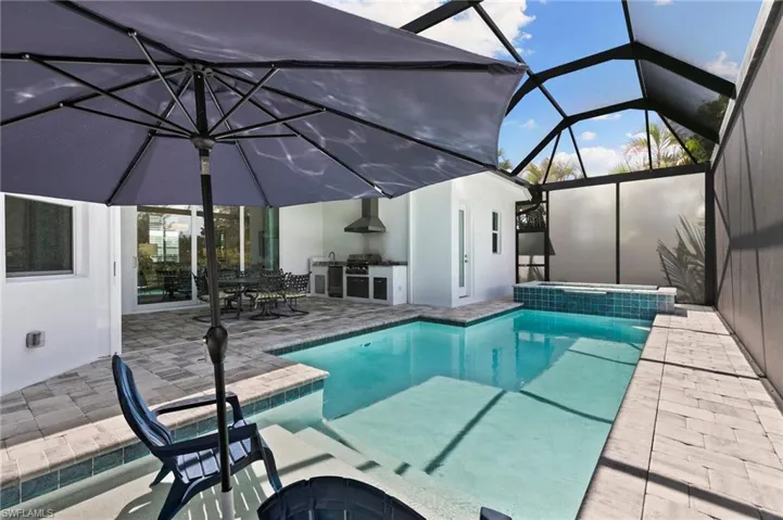 Paver pool deck, privacy screens on both sides adjacent to neighboring properties.