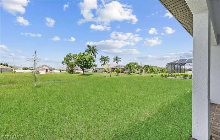 View of yard featuring glass enclosure