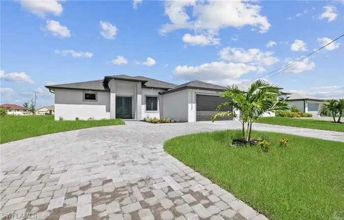 Prairie-style house with a garage and a front lawn