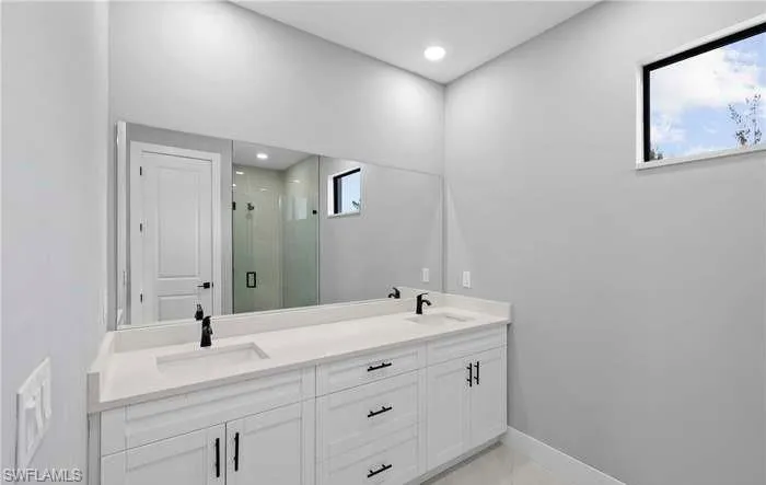 Bathroom with vanity and a shower with shower door