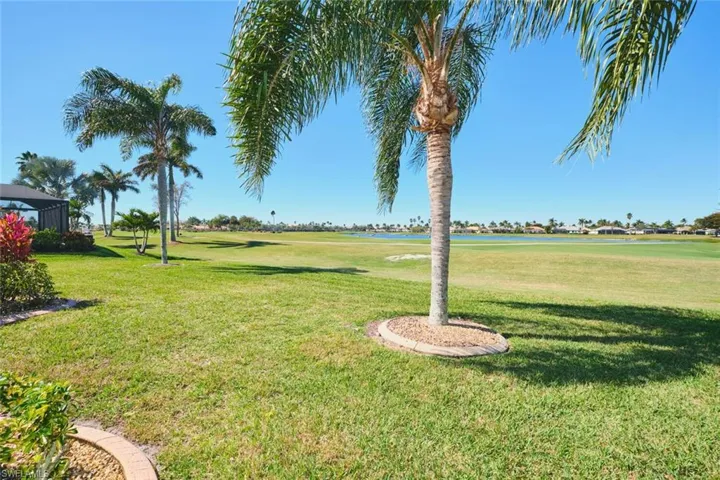 View of grassy yard with a water view and golf course view