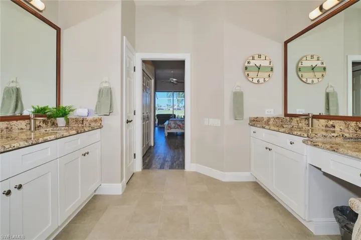 Full bathroom with two vanities and ensuite bath