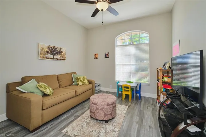 Living room featuring wood finished floors and ceiling fan