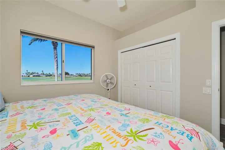 Bedroom with a ceiling fan and a closet