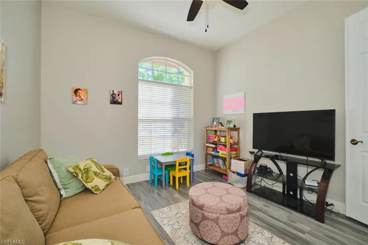 Recreation room featuring wood finished floors and ceiling fan