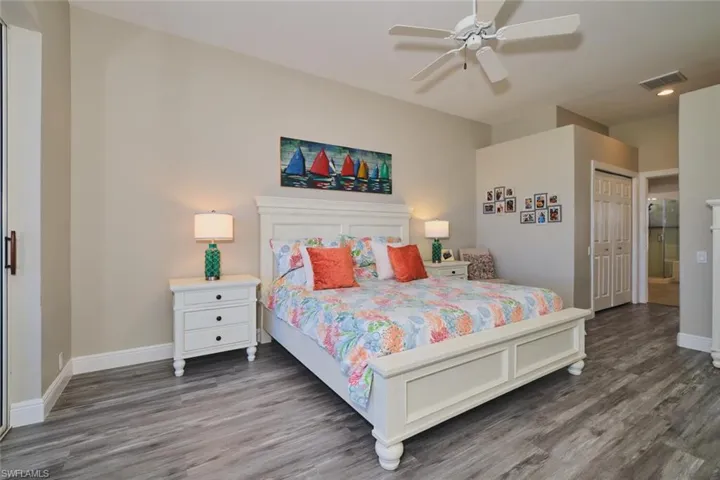 Bedroom with wood finished floors, ceiling fan, and a closet