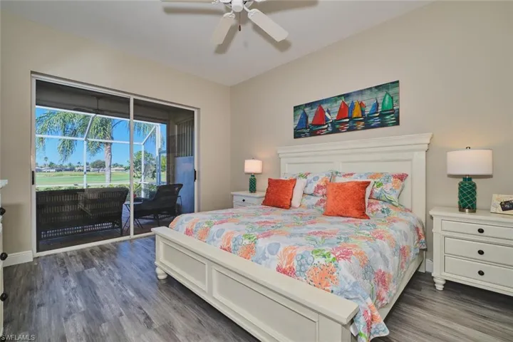 Bedroom featuring access to exterior, dark wood finished floors, and ceiling fan