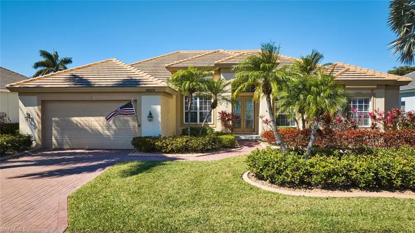 View of front of home featuring a garage, stucco siding, decorative driveway, and a tiled roof