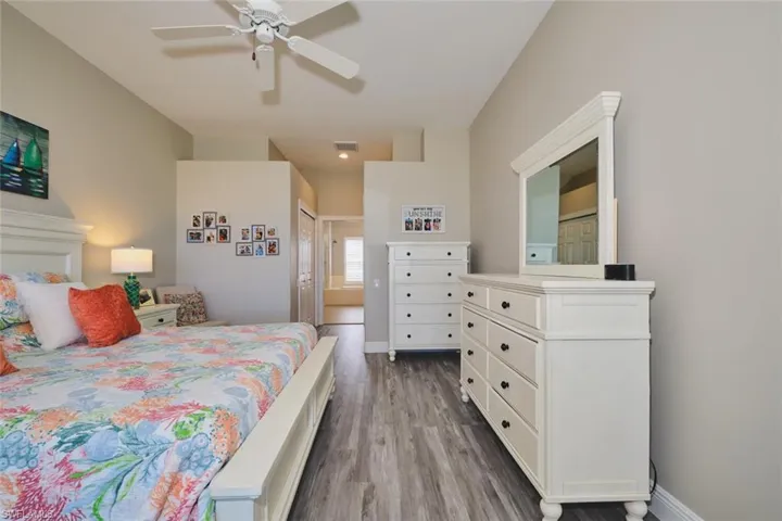 Bedroom featuring dark wood finished floors, a closet, and ceiling fan