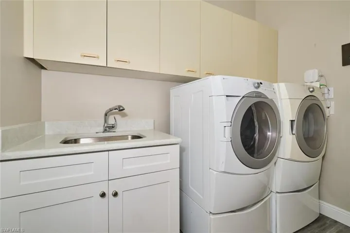 Laundry area featuring cabinet space and washer and clothes dryer