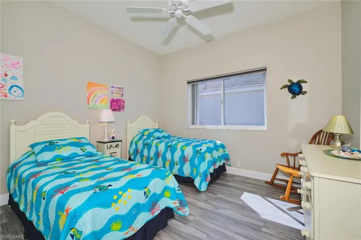 Bedroom with wood finished floors and a ceiling fan
