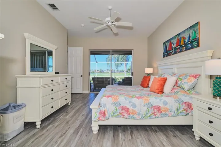 Bedroom with access to outside, light wood-style floors, and ceiling fan