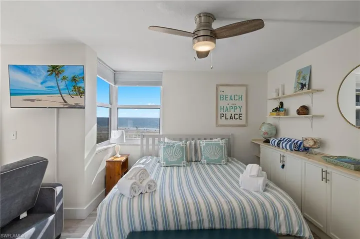 Bedroom with ceiling fan and light hardwood / wood-style flooring