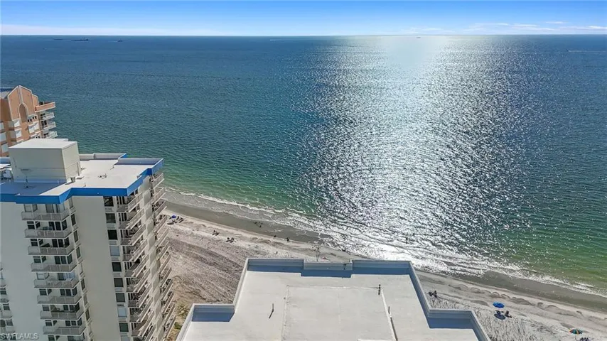 Drone / aerial view with a water view and a view of the beach