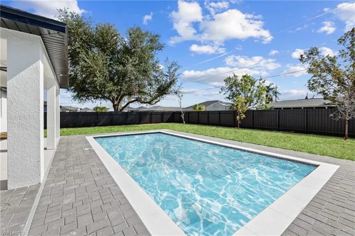 View of swimming pool featuring a lawn and a patio