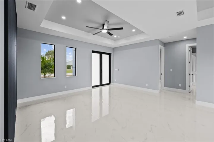 Spare room with ceiling fan and a raised ceiling