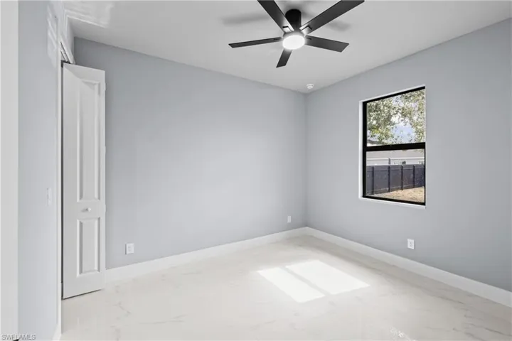 Spare room with ceiling fan