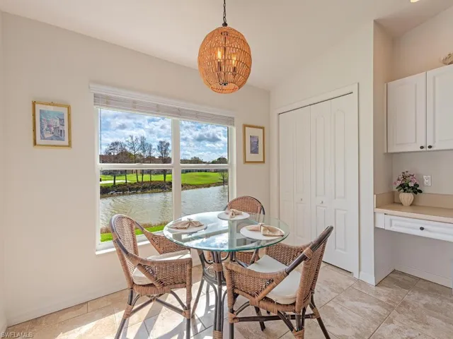 Dining area with a water view and hanging lights