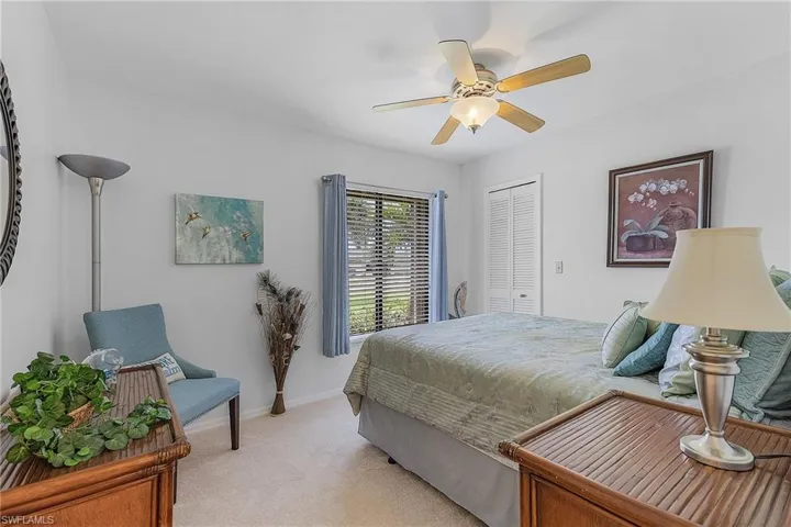 Bedroom with light carpet, a closet, and ceiling fan