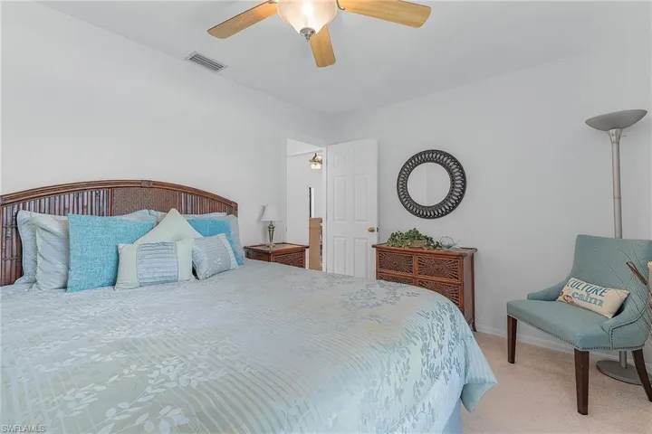 Carpeted bedroom with baseboards and a ceiling fan