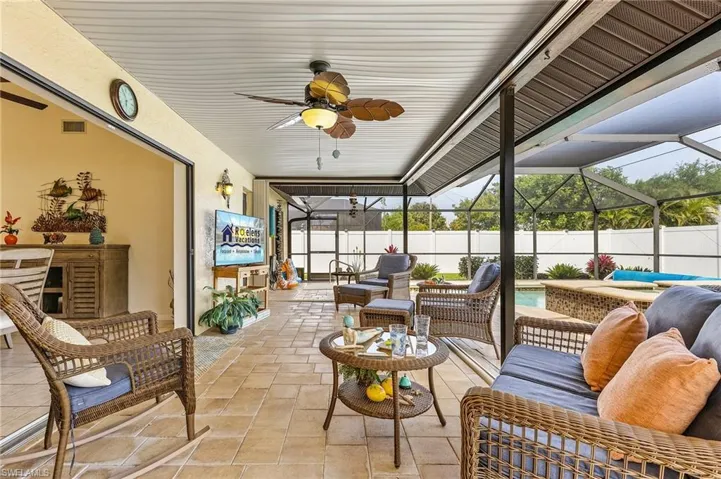 Sunroom / solarium featuring an outdoor hangout area, a ceiling fan, and a patio area