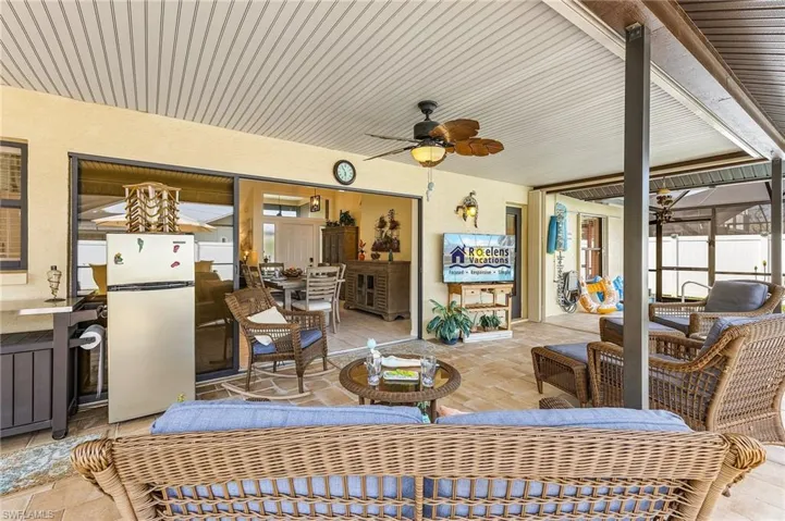Sunroom / solarium with a ceiling fan, a patio area, and outdoor seating