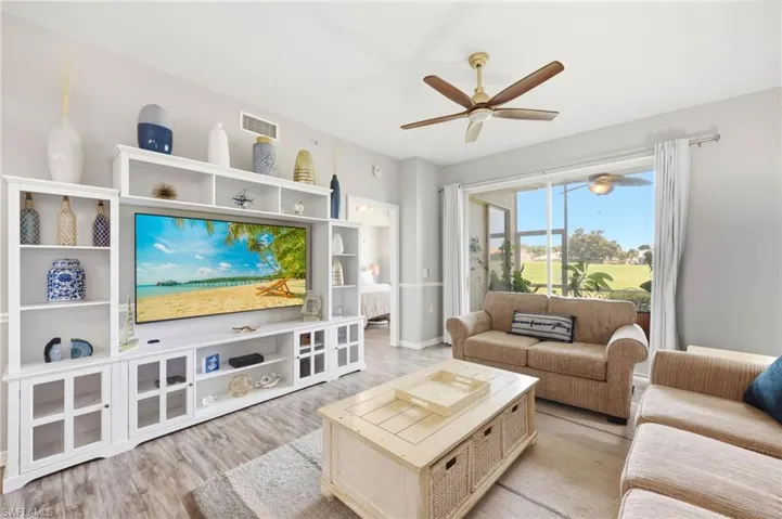 Light wood-finish flooring complements the neutral wall tones