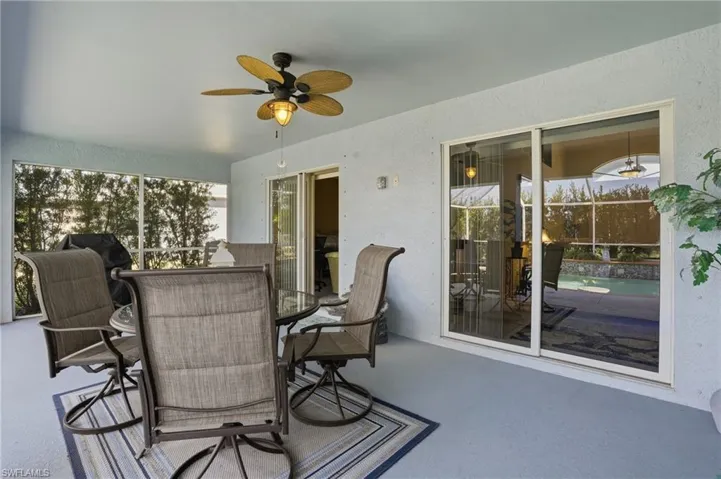 View of patio / terrace with ceiling fan, outdoor dining space, and a sunroom