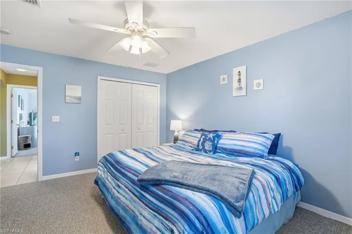 Bedroom with carpet flooring, a closet, and ceiling fan