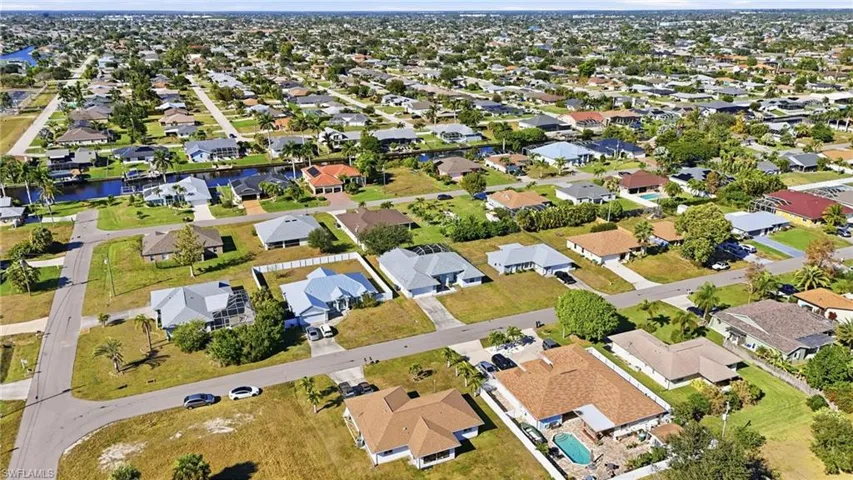 Aerial view of property's location with nearby suburban area