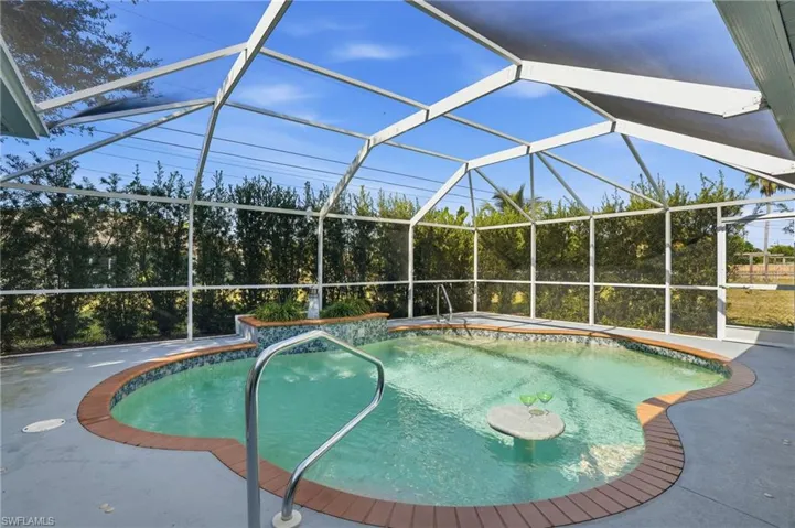 Outdoor pool featuring a lanai, a sunroom, and a patio area
