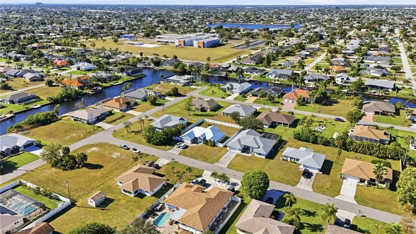 Aerial view of property's location featuring nearby suburban area and a large body of water