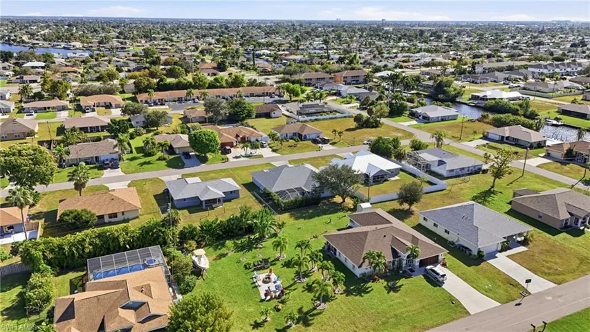 Aerial perspective of suburban area with a nearby body of water