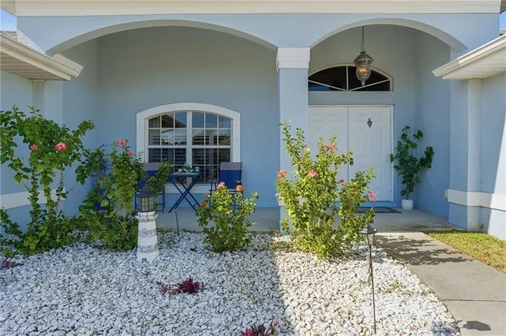 Property entrance featuring stucco siding
