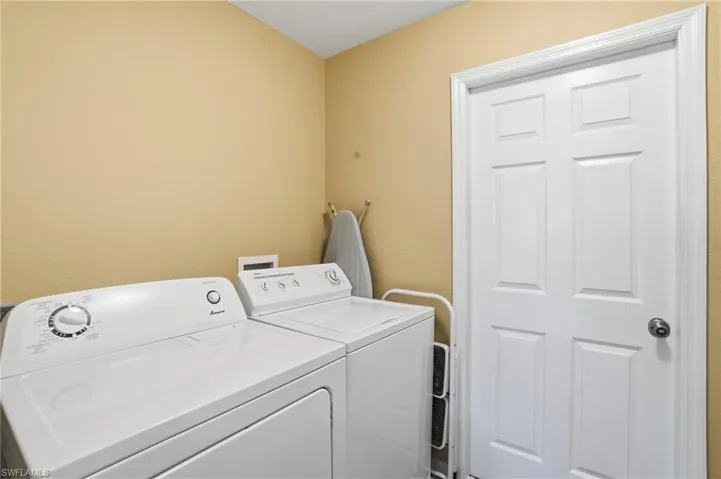 Laundry room with washer and clothes dryer