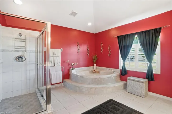Bathroom featuring a garden tub, a shower stall, tile patterned floors, and recessed lighting