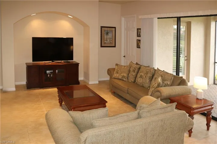 Tiled family featuring plenty of natural light, tiled floor and ornamental molding.