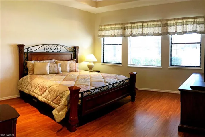 Large airy Bedroom with wood finished floors