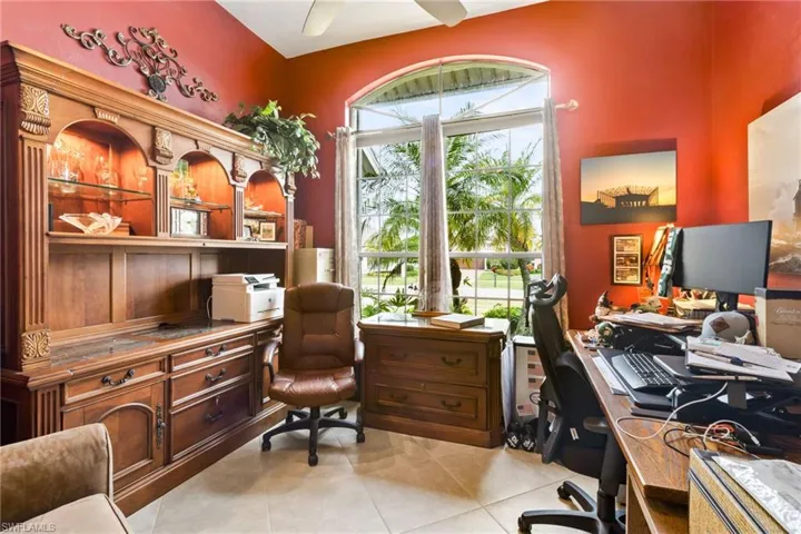 Tiled office featuring a wealth of natural light and ceiling fan
