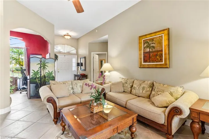 Living room with ceiling fan and tile flooring