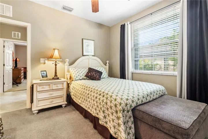 Bedroom featuring ceiling fan and light tile floors