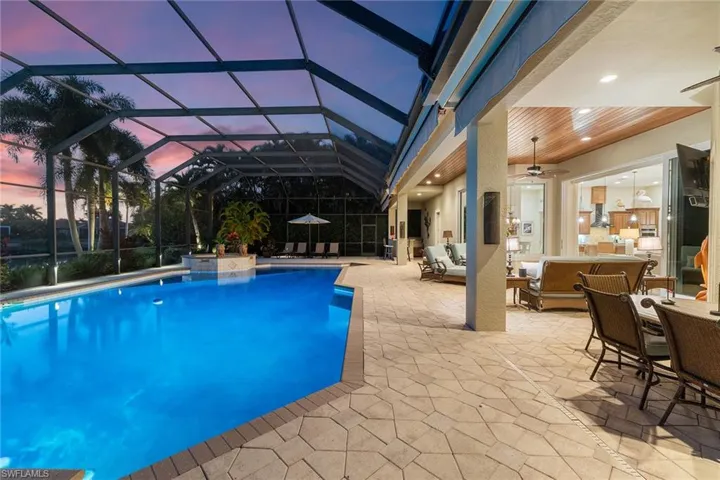Outdoor pool with outdoor lounge area, a patio, a sunroom, a lanai, and outdoor dining area