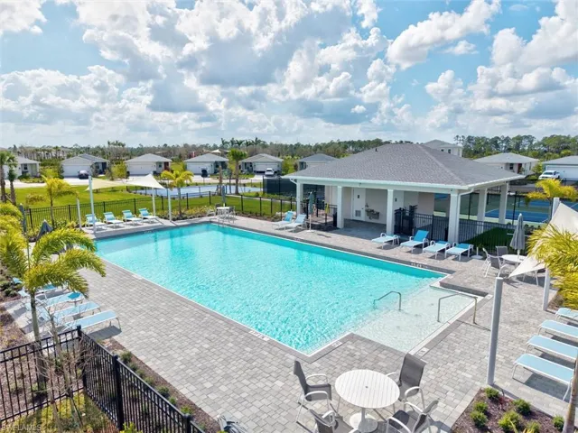 Community pool featuring a patio and a residential view